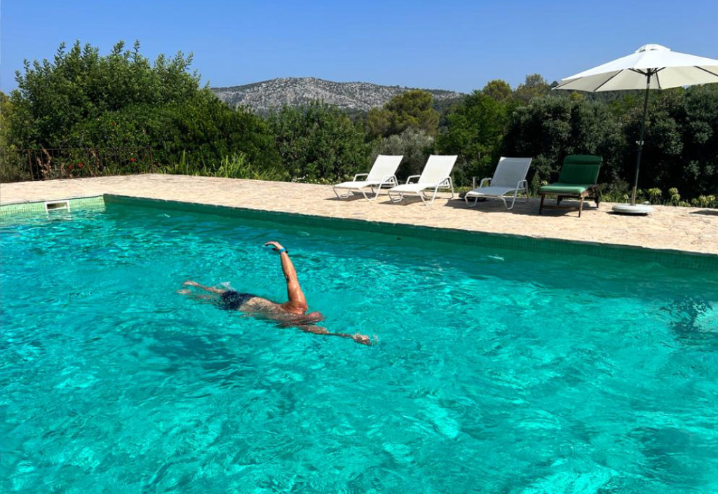 Steven swimming in outdoor pool in Portugal